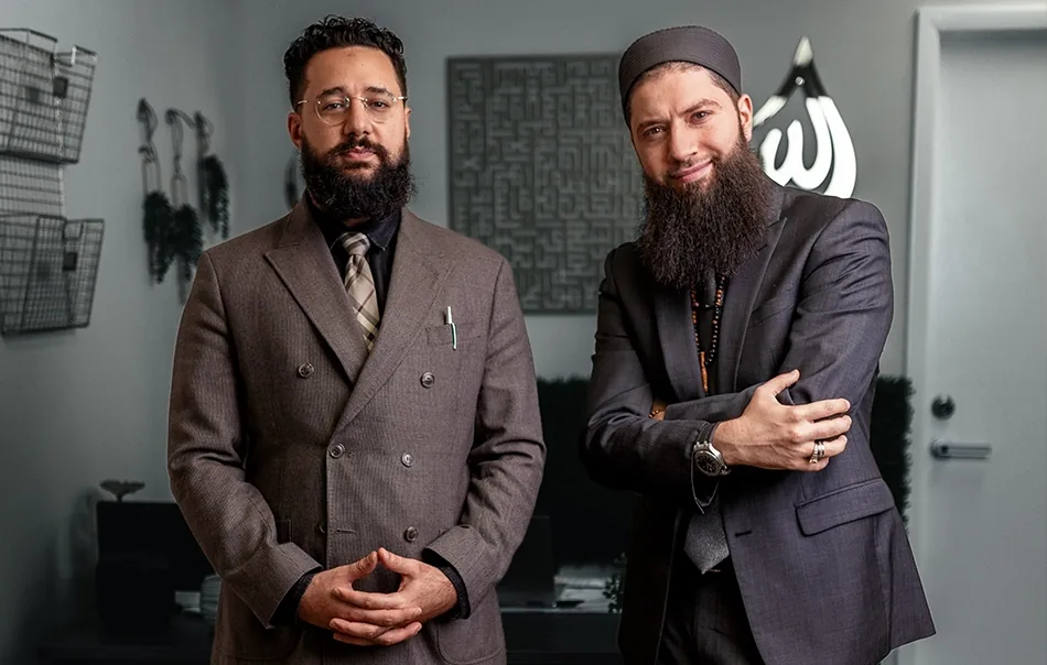 Two Muslim Legal attorneys standing in the firm's Temple Terrace office